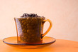 Orange cup with coffee beans Orange cup with coffee beans