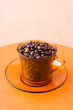 Orange cup with coffee beans Orange cup with coffee beans