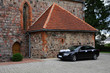 Black wedding limo by the church