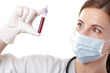 A young female health professional looking at a blood sample