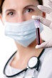 A young female health professional looking at a blood sample