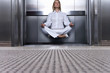 Businesswoman levitating in elevator