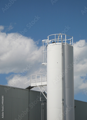 Photo: white tall industrial silo white tall industrial silo