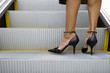 Womans feet on escalator