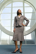 Businesswoman standing in front of round window