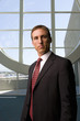Photo: Businessman standing in front of round window Businessman standing in front of round window
