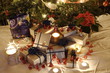 Christmas presents and candles under the tree Christmas presents and candles under the tree