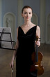 The beauty brunette plays the violin in concert hall