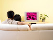 A couple watching television in the living room