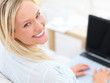 portrait of a happy young businesswoman using laptop