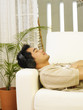 man relaxing at sofa listening to music