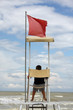 Photo: Lifeguard station,Lifeguard man watching the sea in Italy Lifeguard station,Lifeguard man watching the sea in Italy