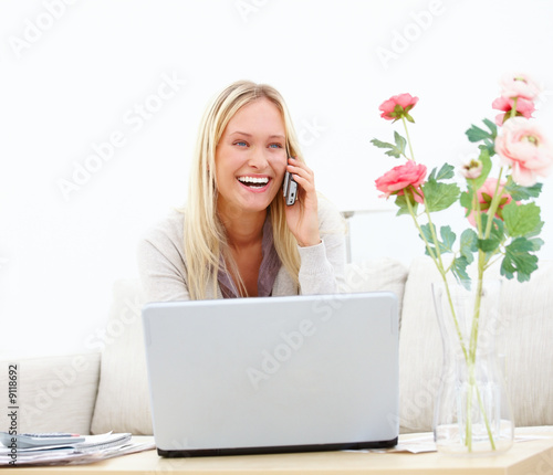 Closeup of a laughing young girl talking on mobile phone