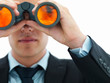 Closeup of a young business man looking through binocular Closeup of a young business man looking through binocular