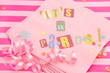 cut out letters spelling it's a party on pink napkins