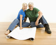 Photo: Man and woman with blueprints. Man and woman with blueprints.