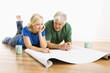 Photo: Man and woman discussing blueprints. Man and woman discussing blueprints.