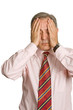 Businessman in a suit gestures with a headache