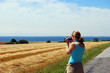 Young lady takes a picture of a beautiful seaside