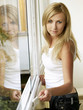 Photo: Beautiful blonde girl painting the window Beautiful blonde girl painting the window