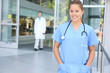 A pretty woman nurse outside hospital office building A pretty woman nurse outside hospital office building