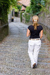 Rear view of a female walking down stairs in in italy
