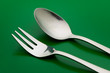 arrangement of table silverware over green background