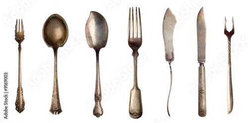 Photo: Vintage spoons, forks and knifes isolated on white Vintage spoons, forks and knifes isolated on white