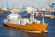 container ship with cargo moving through harbor