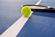 Tennis ball and racquet on the court Tennis ball and racquet on the court