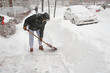 Woman shoveling after a snow storm. Canada.