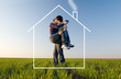 The guy holds the girl on hands, kisses and dreams about house The guy holds the girl on hands, kisses and dreams about house