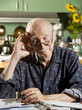 Elder Man at Home with Bills