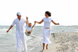 Father and mother playing on beach with little son