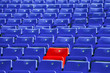 plastic blue sit rows with only one red,shallow deep of field
