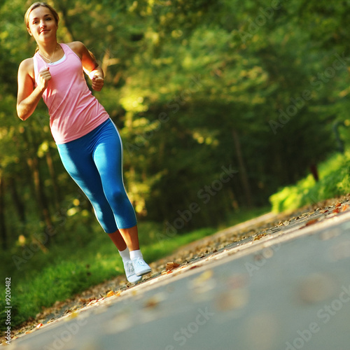 Photo: Pretty young girl runner in the forest. Pretty young girl runner in the forest.
