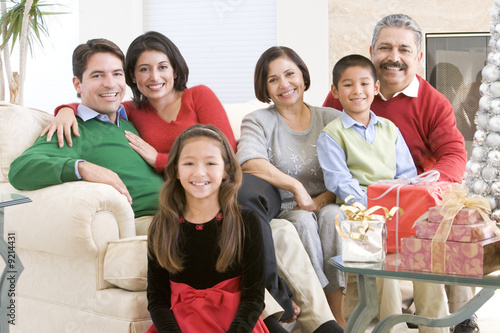Photo: Family Sitting Around A Coffee Table And Christmas Gifts Family Sitting Around A Coffee Table And Christmas Gifts