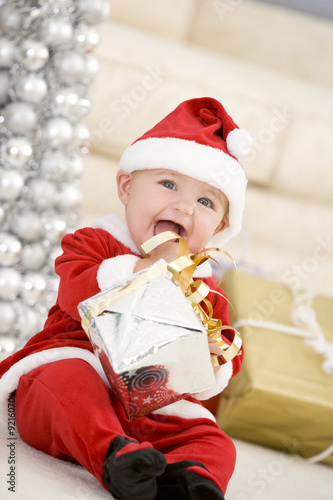 Photo: Baby In Santa Costume At Christmas Baby In Santa Costume At Christmas