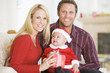 Couple With Baby In Santa Outfit