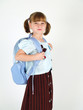 smiling young school girl with backpack