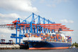 container ship in port terminal - huge freighter fully loaded
