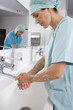 Female surgeon and surgeon washing hands