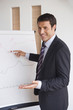Business man writing on flipchart