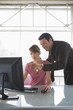 Business man and woman working on computer, teamwork