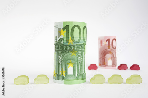 Photo: Rolled euro notes and car-shaped gumdrops Rolled euro notes and car-shaped gumdrops