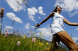 Young woman Nordic walking in meadow, Germany, low angle view