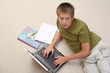 Boy learning at home with notebook .