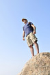 Middle aged hiker standing on top of a mountain