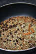 toasted spicy rub in pan to enhance a flavor, macro, shallow DOF toasted spicy rub in pan to enhance a flavor, macro, shallow DOF