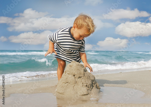 Photo: baby boy playing on beach baby boy playing on beach